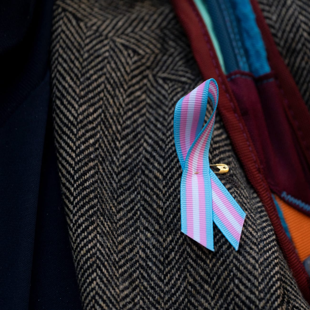 A supporter wears a pro-trans ribbon, in Seattle, Washington, on February 28, 2025.