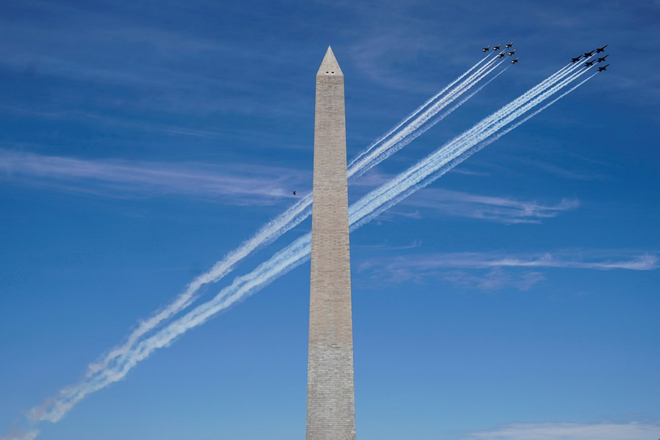 A formation of the Navy Blue Angels and Air Force Thunderbirds fly past the Washington Monument as a salute to first responders and essential personnel during the coronavirus pandemic on May 2, 2020. The photo shows two tight formations of several jets flying by the Washington monument on a brilliant blue sky day. REUTERS/Joshua Roberts