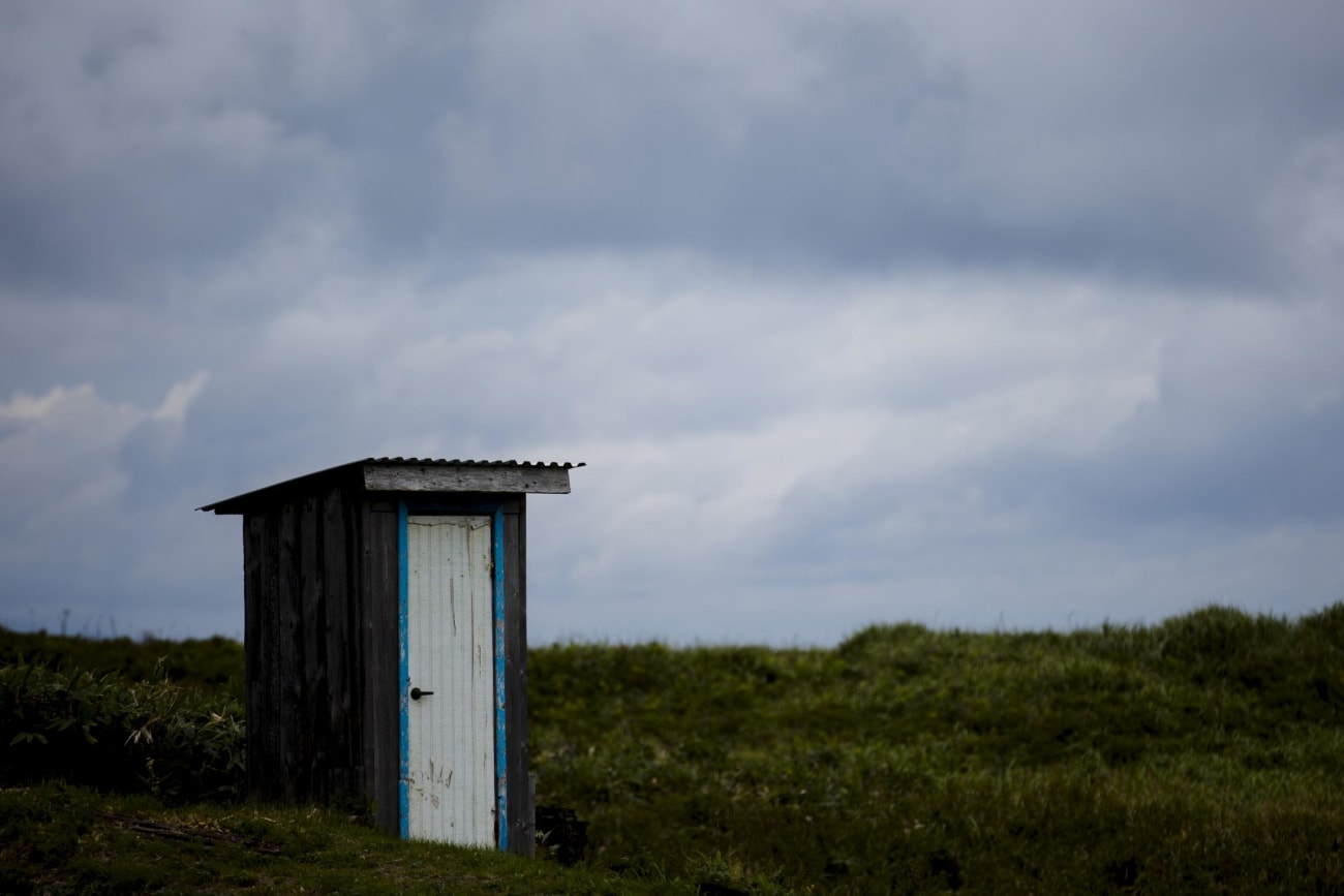 A toilet stands in a field on private property in the town of Yuzhno-Kurilsk on Kunashir Island which is part of the Kuril Islands group in Russia, September 16, 2015