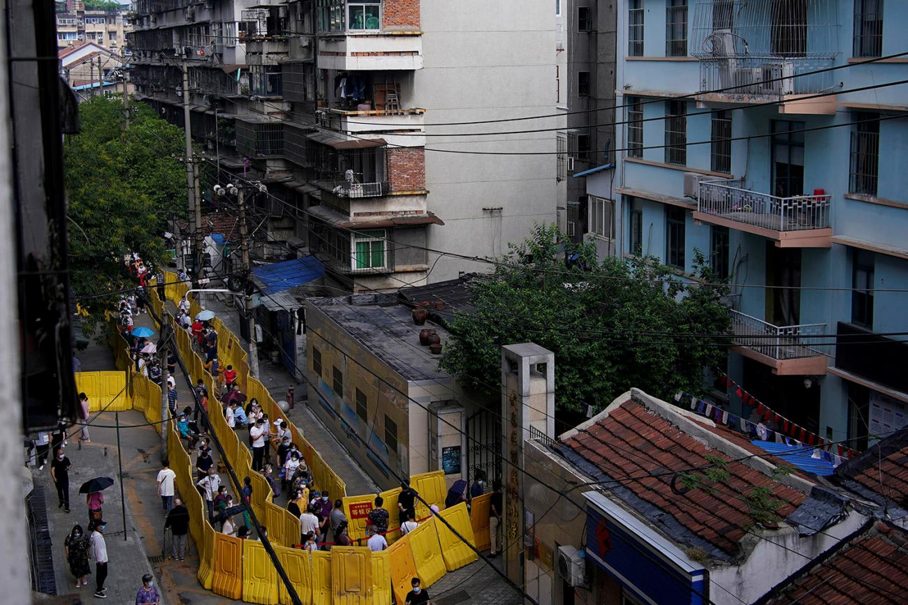 The photo shows a snaking crowd in a neighborhood from above. 