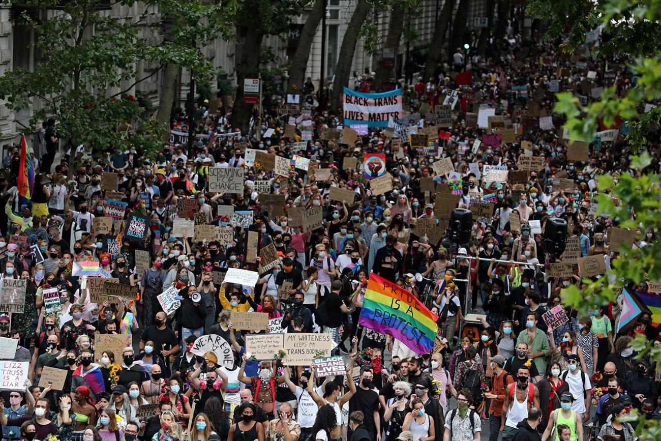 The photo shows a massive demonstration from high above with people walking through the streets of London carrying signs.