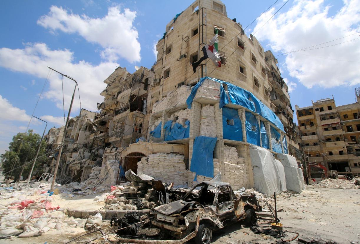 Burnt vehicles are pictured in front of the damaged the Medecins Sans Frontieres (MSF)-backed al-Quds hospital after it was hit by airstrikes, in a rebel-held area of Aleppo, Syria, April 28, 2016.