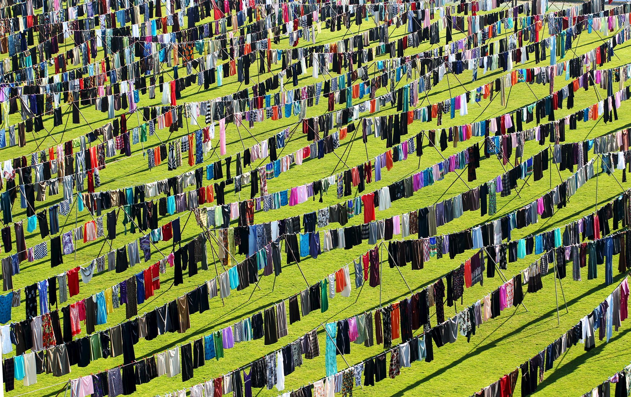 An exhibition by artist Alketa Xhafa-Mripa features thousands of dresses on clotheslines to draw attention to the tragedy of wartime sexual violence. Kosovo National Stadium, in Pristina, June 2015.