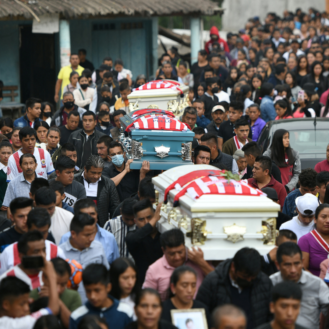 Relatives and friends carry the caskets of Jair Valencia, 19, Yovani Valencia, 16, and Misael Olivares, 16, at their funeral in San Marcos Atexquilapan, in Veracruz State, Mexico, on July 15, 2022. The young men died in a human smuggler's overheated truck in Texas, in June 2022. 