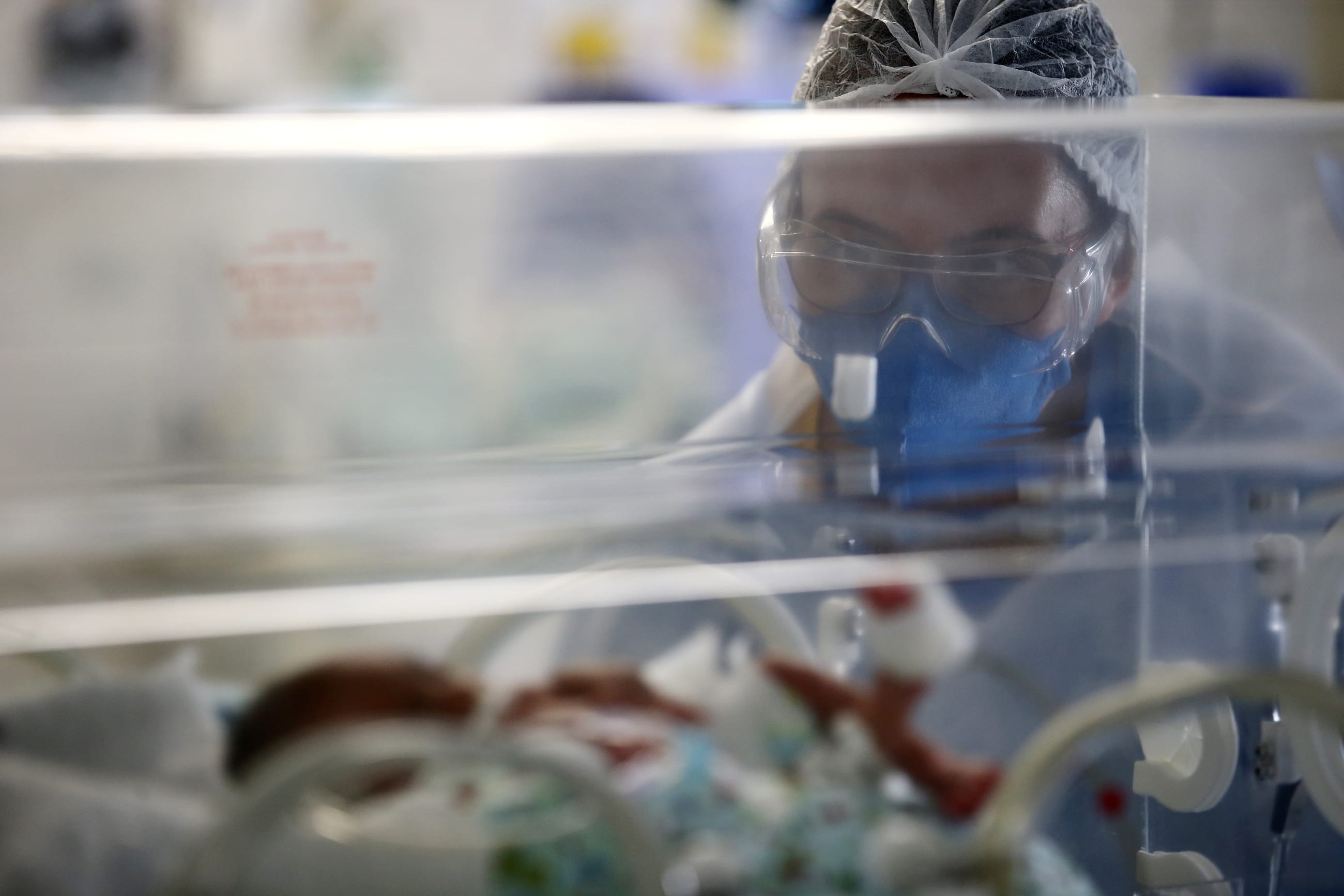 A nurse takes care of a newborn baby in an incubator at the intensive care unit of the Nossa Senhora da Conceicao hospital, after the baby's mother was tested positive for coronavirus disease (COVID-19) in Porto Alegre, Brazil, March 11, 2021.