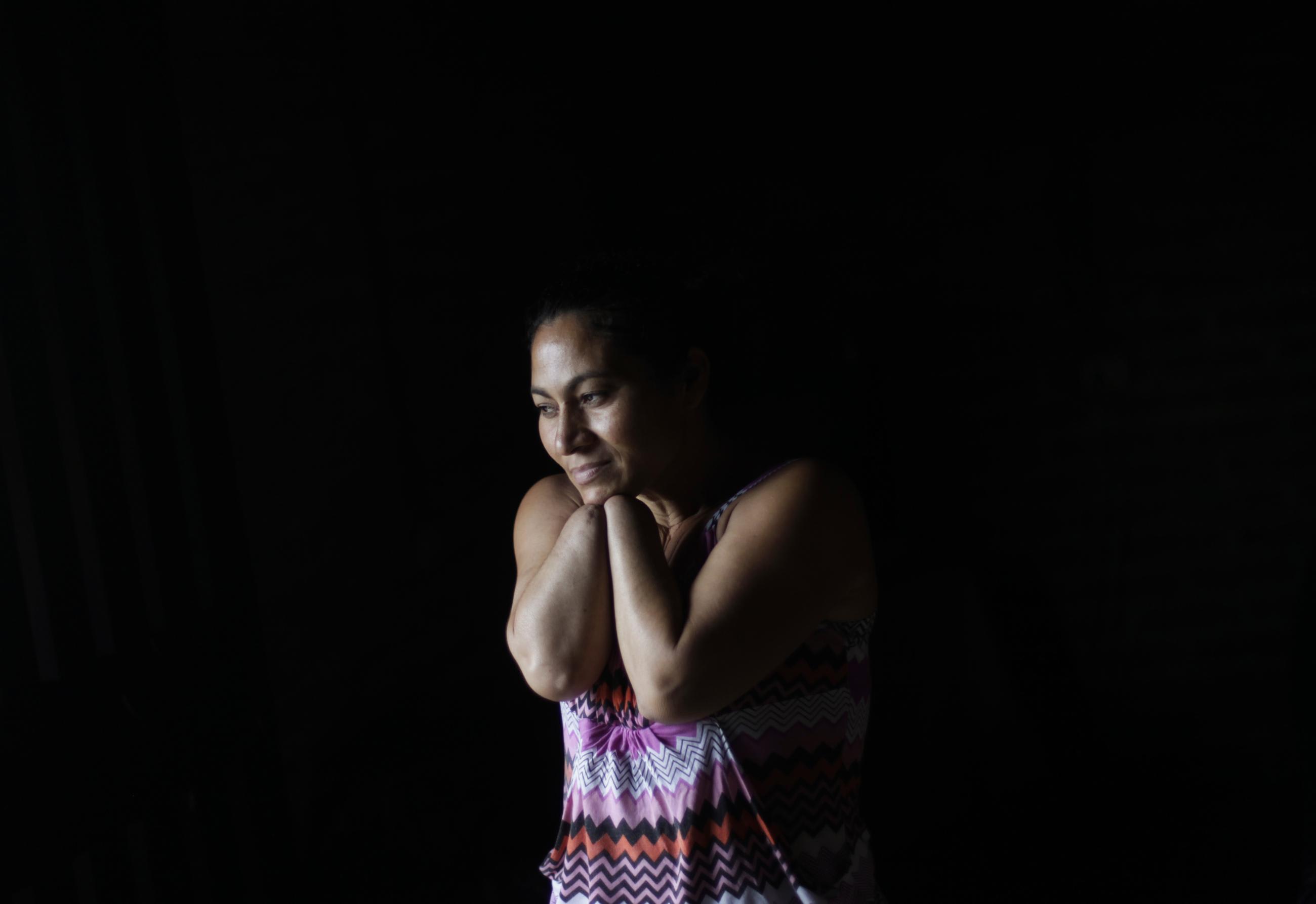 Angelica Maribel Murillo poses for a photograph at her home in La Nueva Australia, Tegucigalpa, Honduras, on August 21, 2013. Angelica's husband attacked her in 2008, accusing her of having an affair.