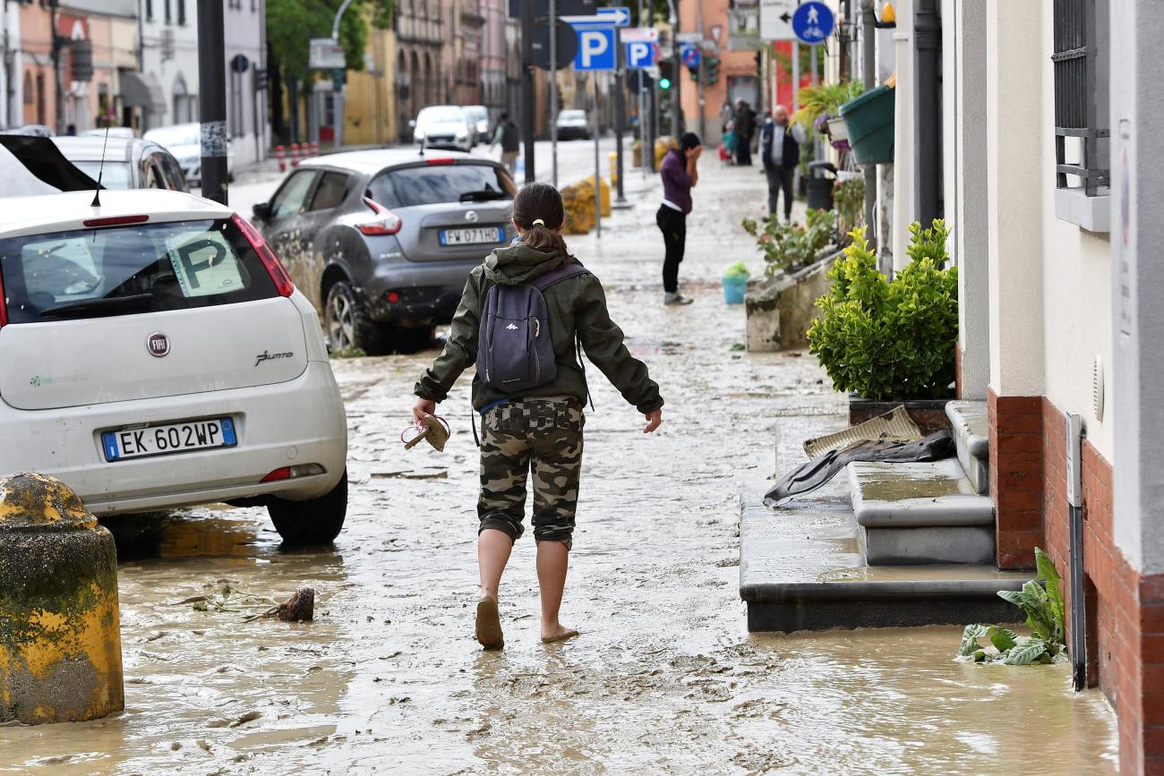 A person walks through mud after heavy rains hit Italy's Emilia Romagna region, in Castel Bolognese, May 18, 2023. 