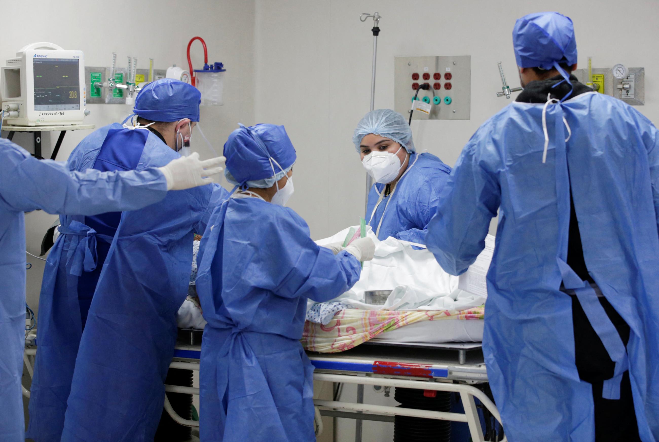 Medical staff treat a COVID-19 patient in the emergency room 