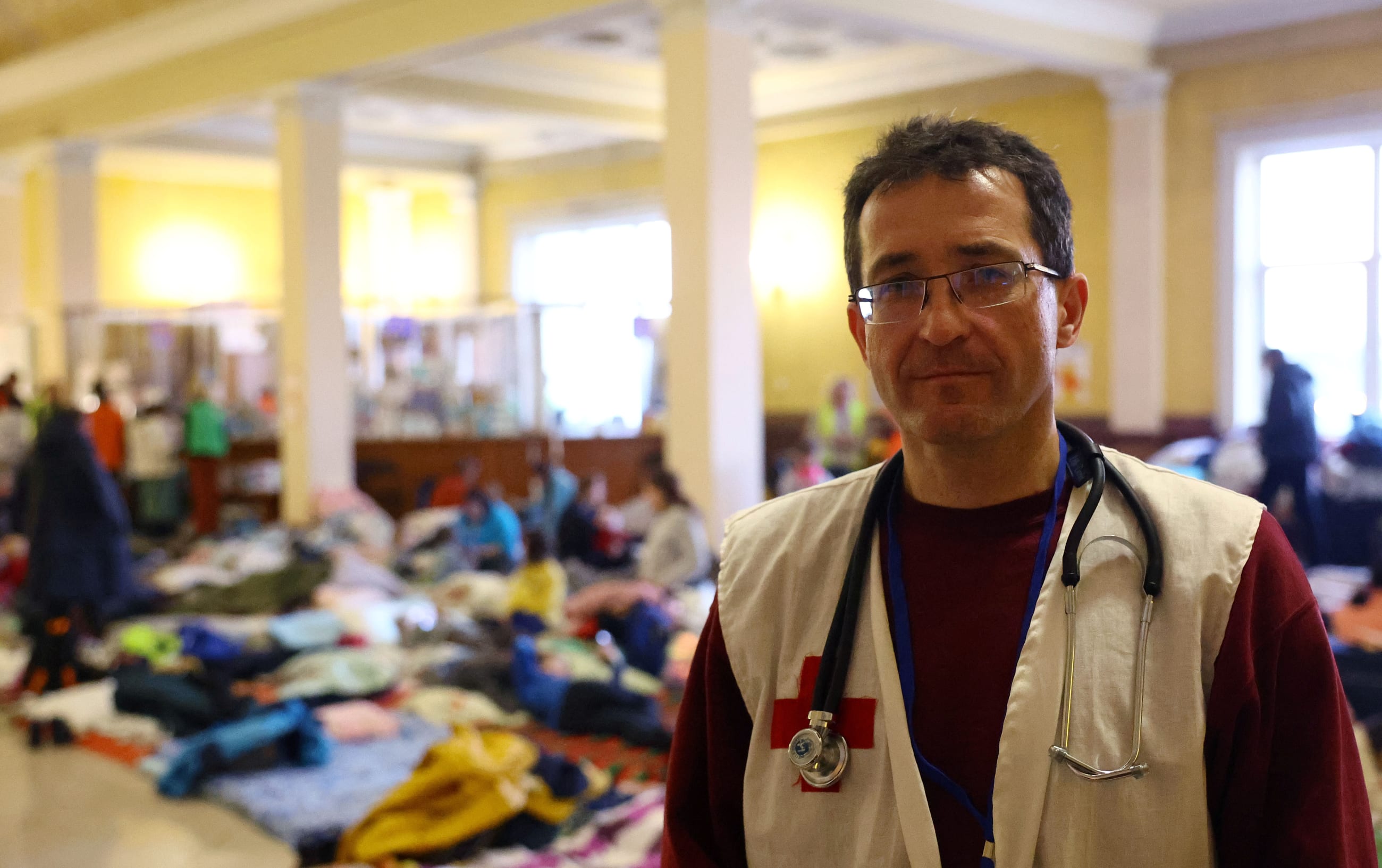 Andrea Sakhaltuyev is seen at a train station that is used as a makeshift first aid station and camp for women and children who fled the ongoing Russian invasion.