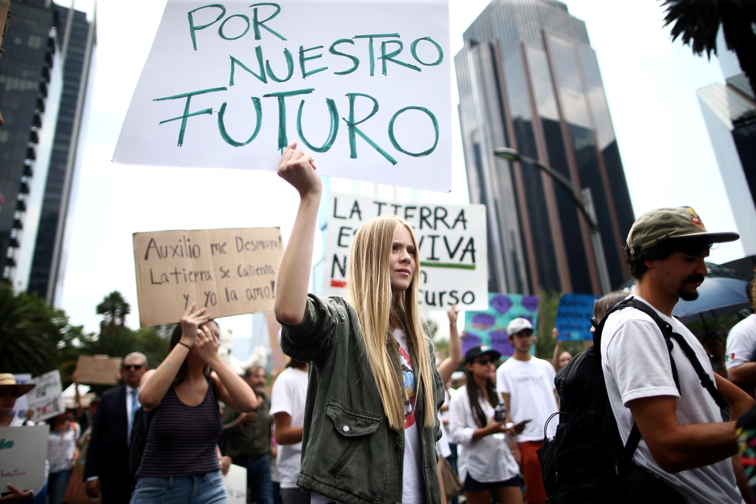 A demonstrator holds a sign that reads 