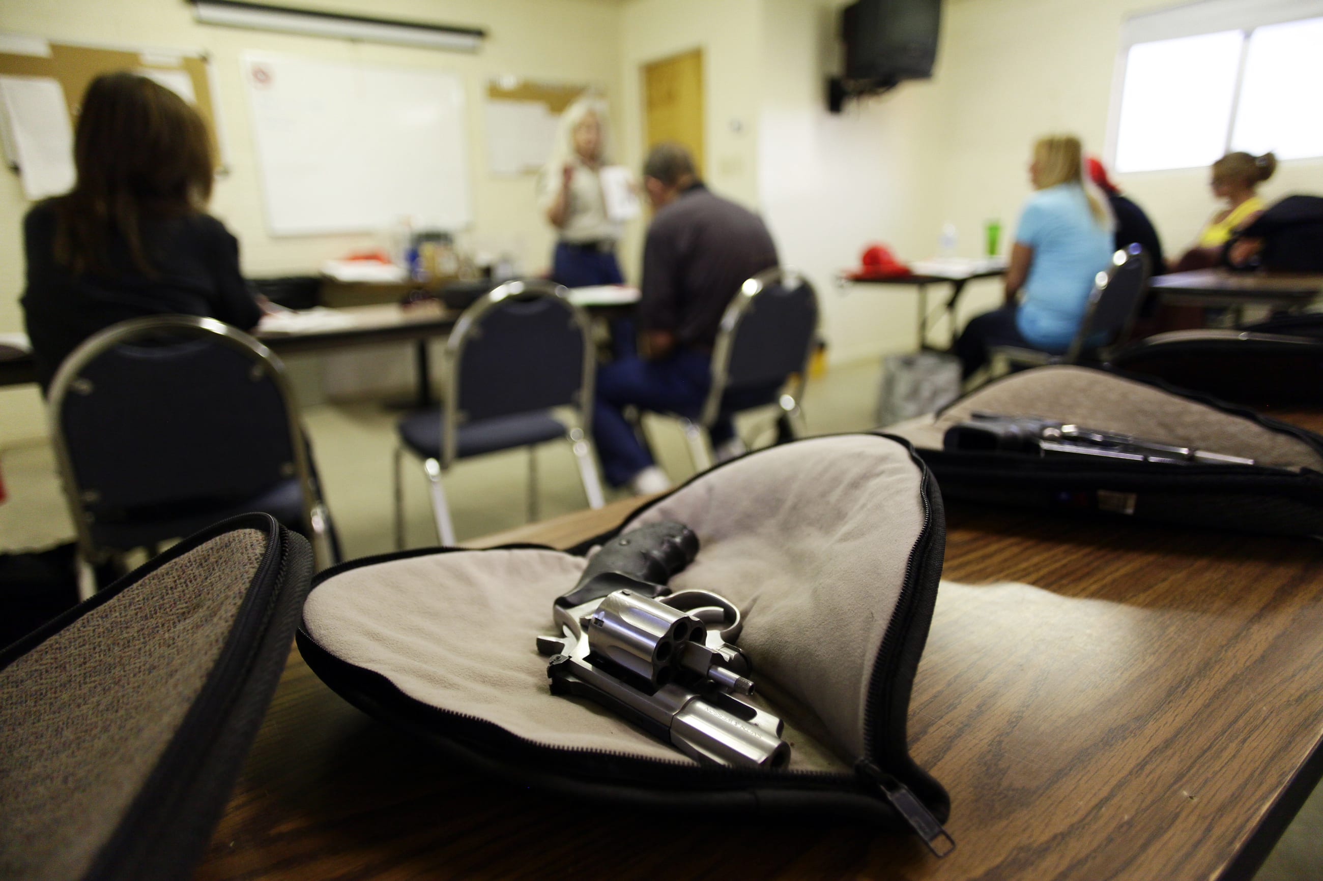 A revolver sits on a table.