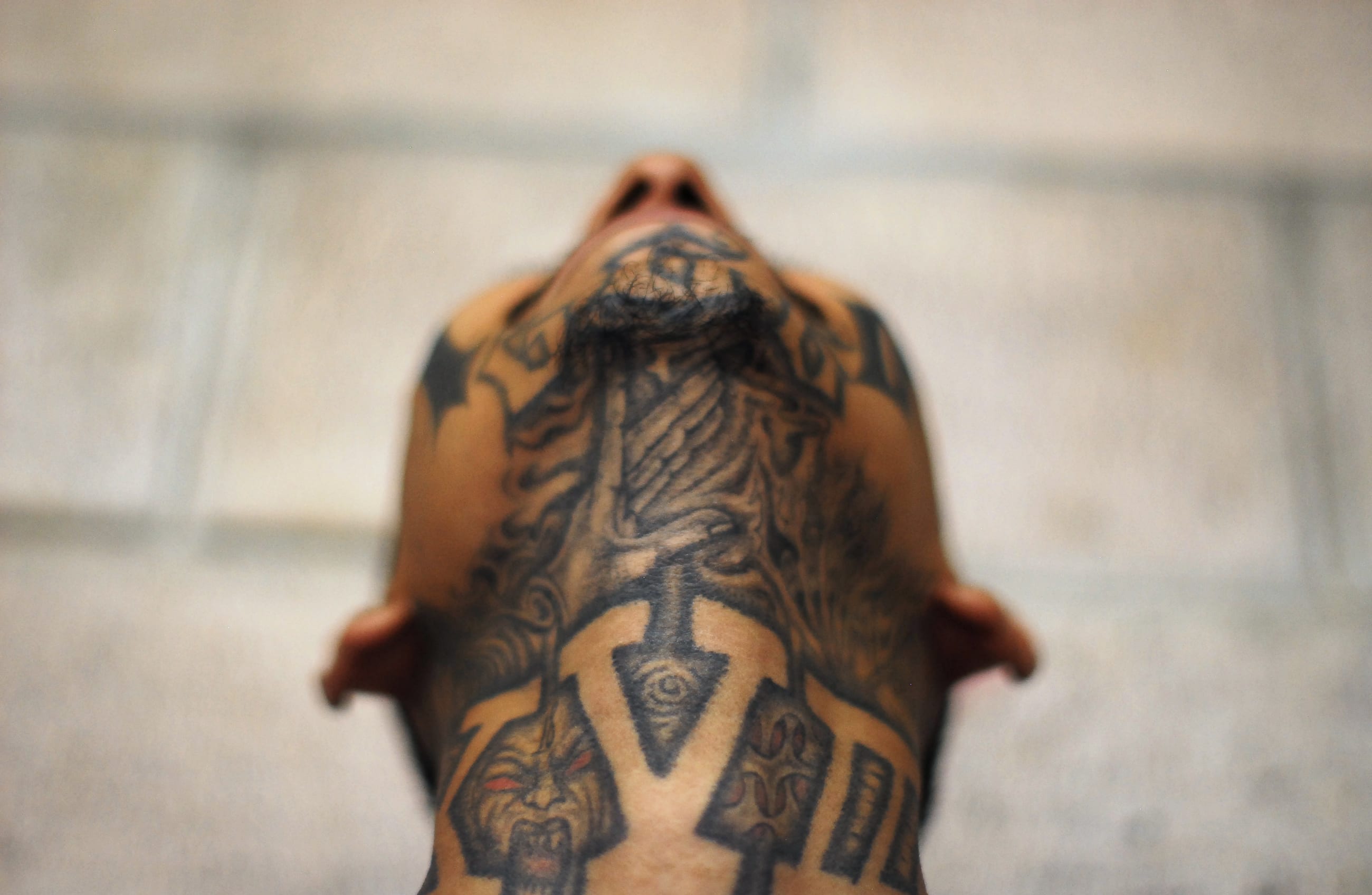 An imprisoned member of street gang Mara 18 poses for a photograph at the Izalco prison.