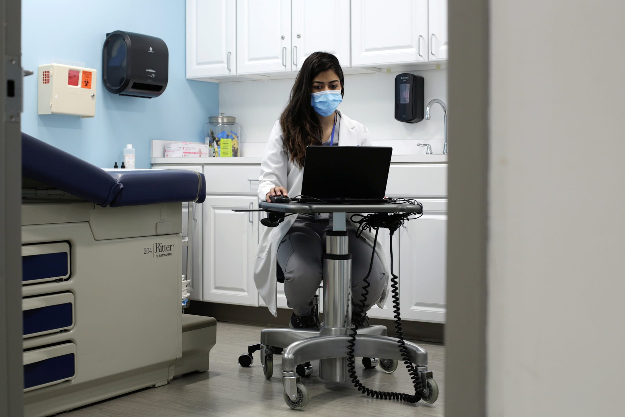 Meera Shah, the chief medical officer for Planned Parenthood Hudson Peconic, communicates with patients online in an unoccupied exam room in White Plains, New York, U.S., April 3, 2020.