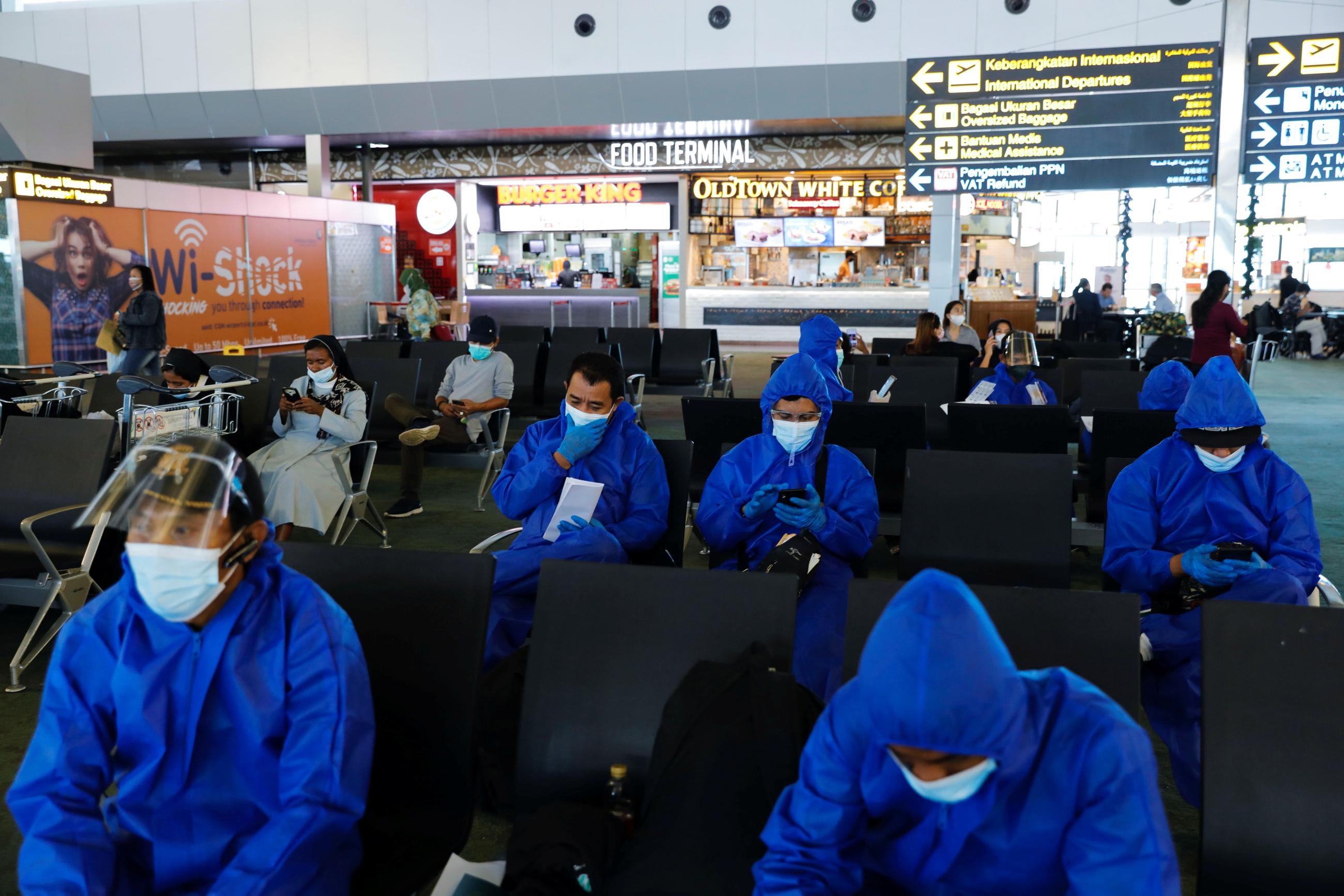 Travelers are seen at Soekarno Hatta International airport, among bans on the arrival of travelers to curb the spread of the Omicron variant of COVID-19