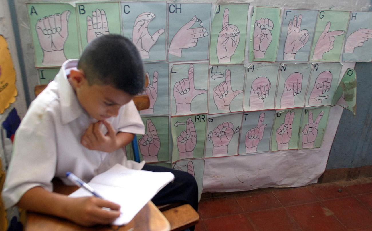 Pedro Guevara studies the alphabet signs on the wall in the Milania Morales School, in Managua, Nicaragua, on September 22, 2004.