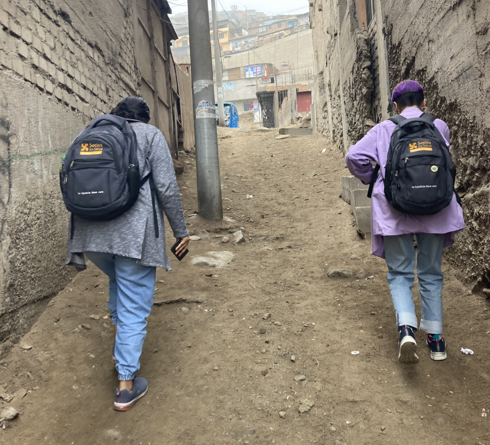 Two CASITA employees walk door-to-door to conduct children's development evaluations in Carabayllo, Lima, on August 24, 2022