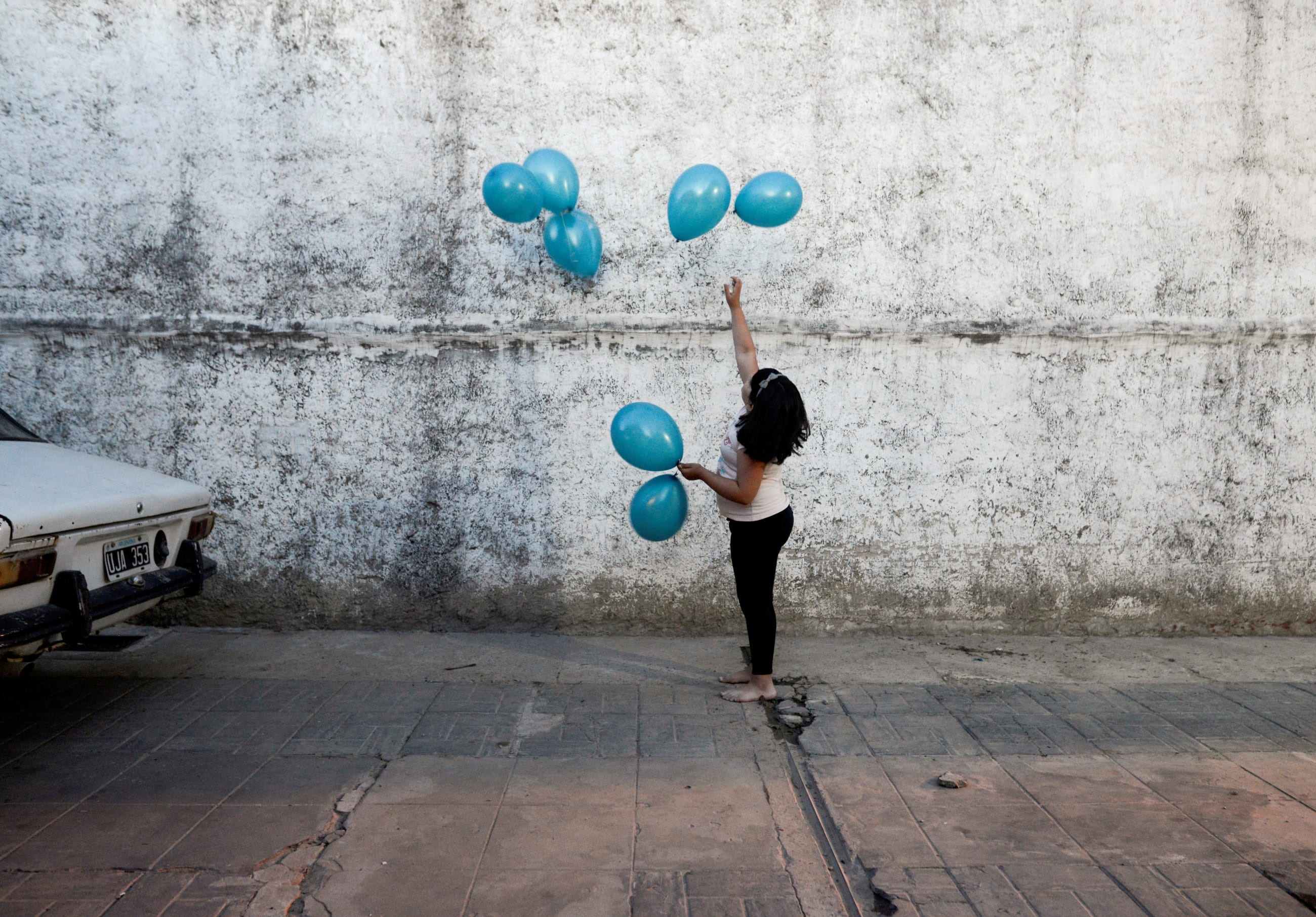 Michell, granddaughter of Rosalia Reyes who was sentenced to eight years in prison after her baby died during a home childbirth, plays with balloons during the welcome party for Rosalia 