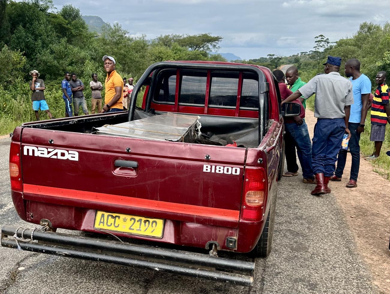 A car carrying a tin coffin is seen on a road in the Chimanimani mountains, near the border of Zimbabwe and Mozambique, in January 2024.