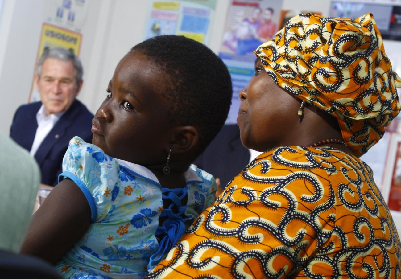 Tatu Msangi (R), who is HIV-positive, holds her daughter Faith during a roundtable on the President's Emergency Plan for AIDS Relief with U.S. President George W. Bush at Amana District Hospital care and treatment clinic in Dar es Salaam February 17, 2008.