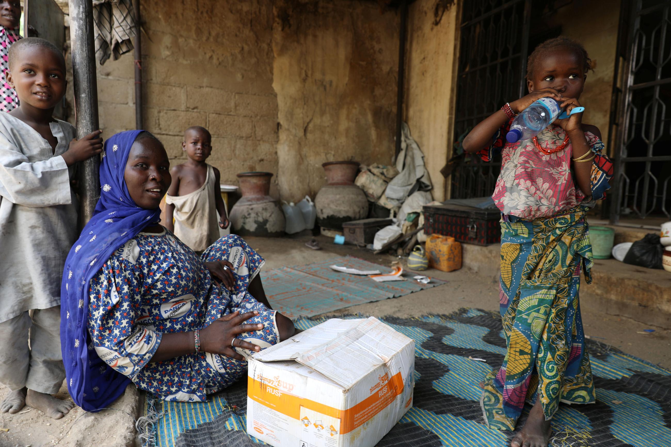 A family is seen with a package of&nbsp;food&nbsp;supplement received from&nbsp;World&nbsp;Food&nbsp;Program at the Banki IDP camp, in Borno, Nigeria, on April 26, 2017. 