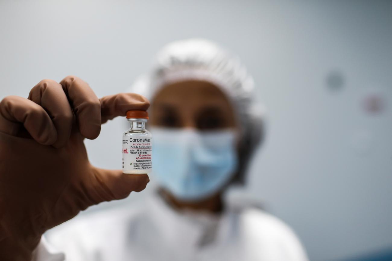 A lab technician holds a vial of Sinovac's CoronaVac COVID-19 vaccine during the inauguration of a production lab, in Constantine, Algeria, on September 29, 2021.