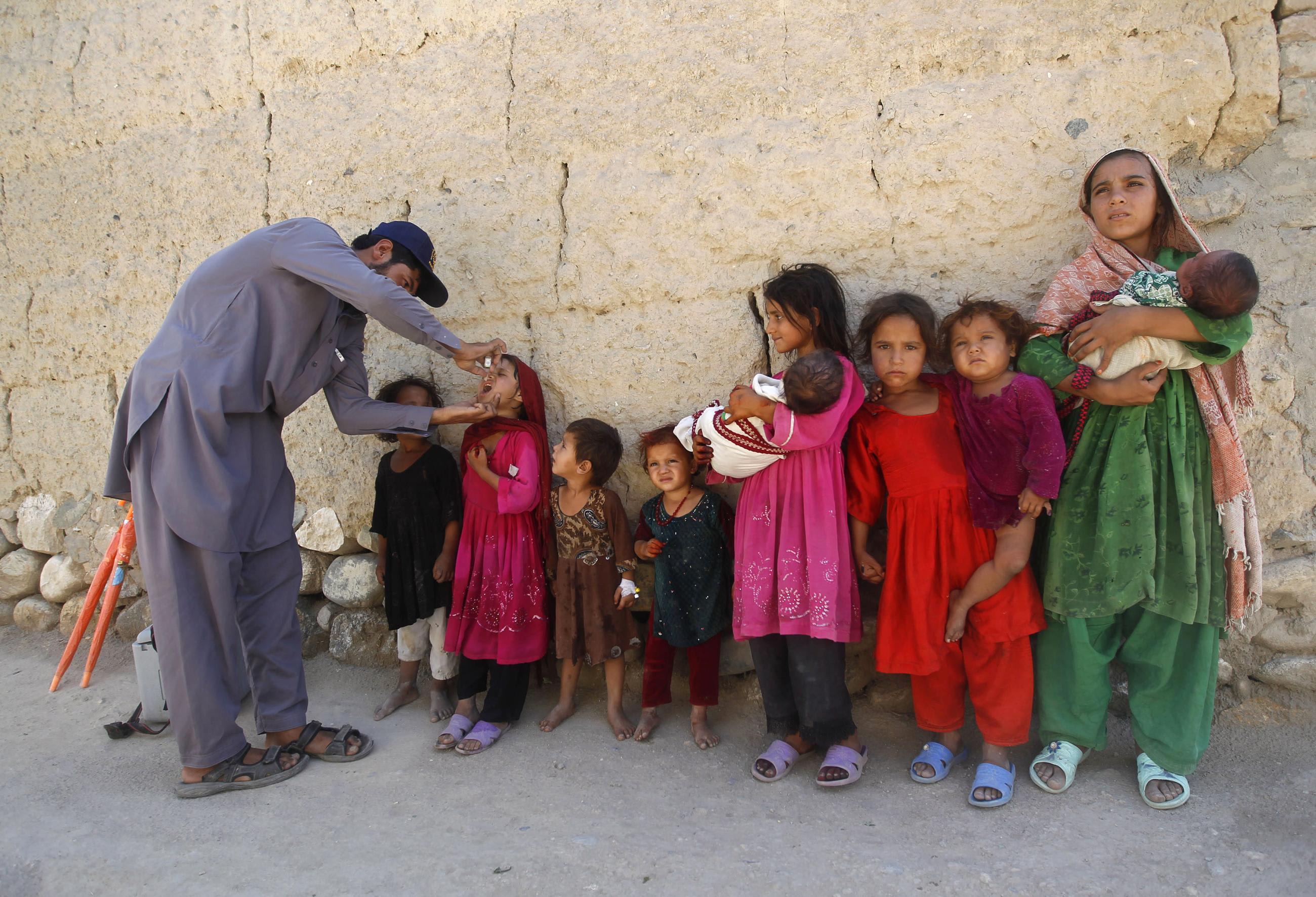 An Afghan child receives polio vaccination drops during an anti-polio campaign, in Jalalabad, Afghanistan, on June 9, 2013.