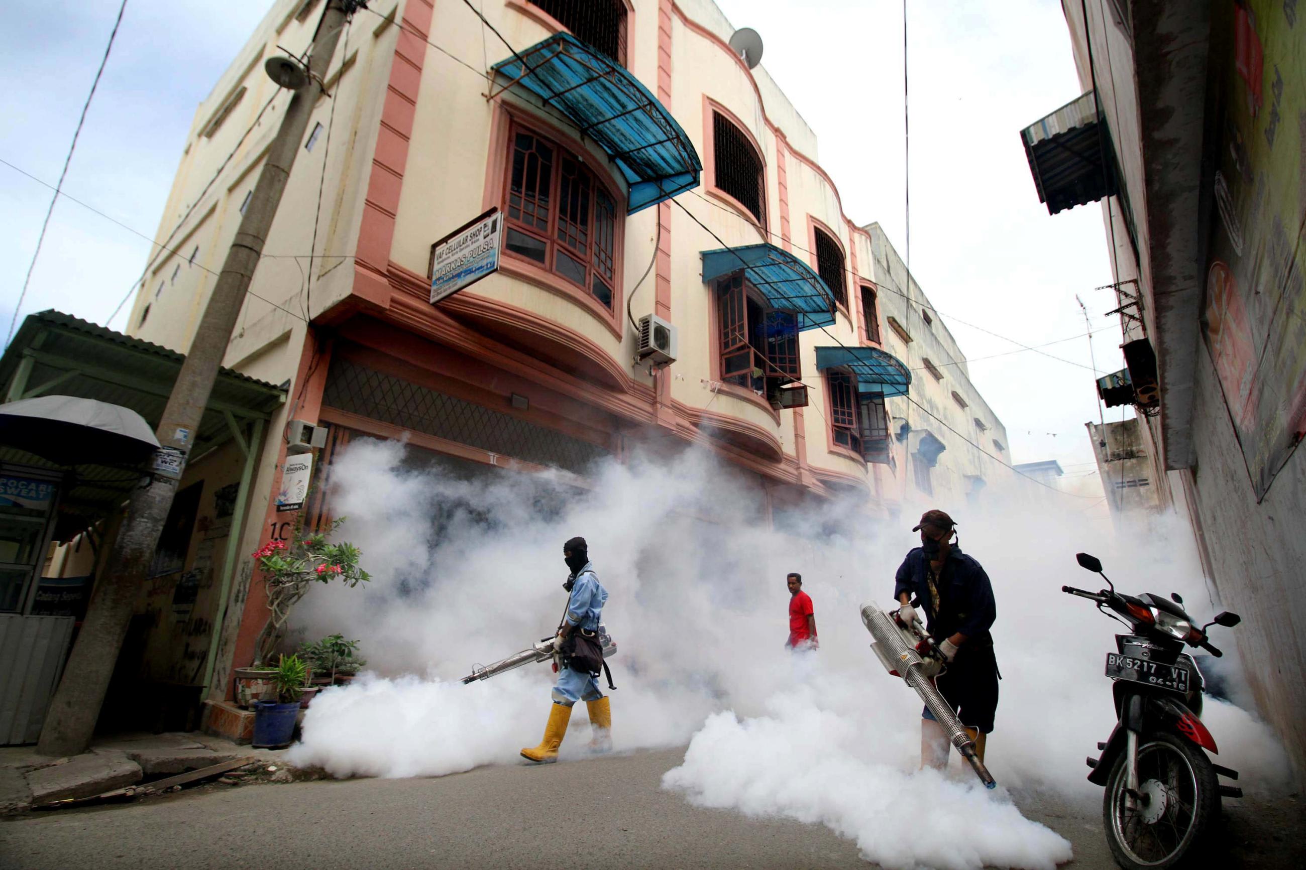 City officers conduct mosquito fogging, at a residential complex, in Lhokseumawe, Aceh province,  Indonesia, on October 26, 2016.