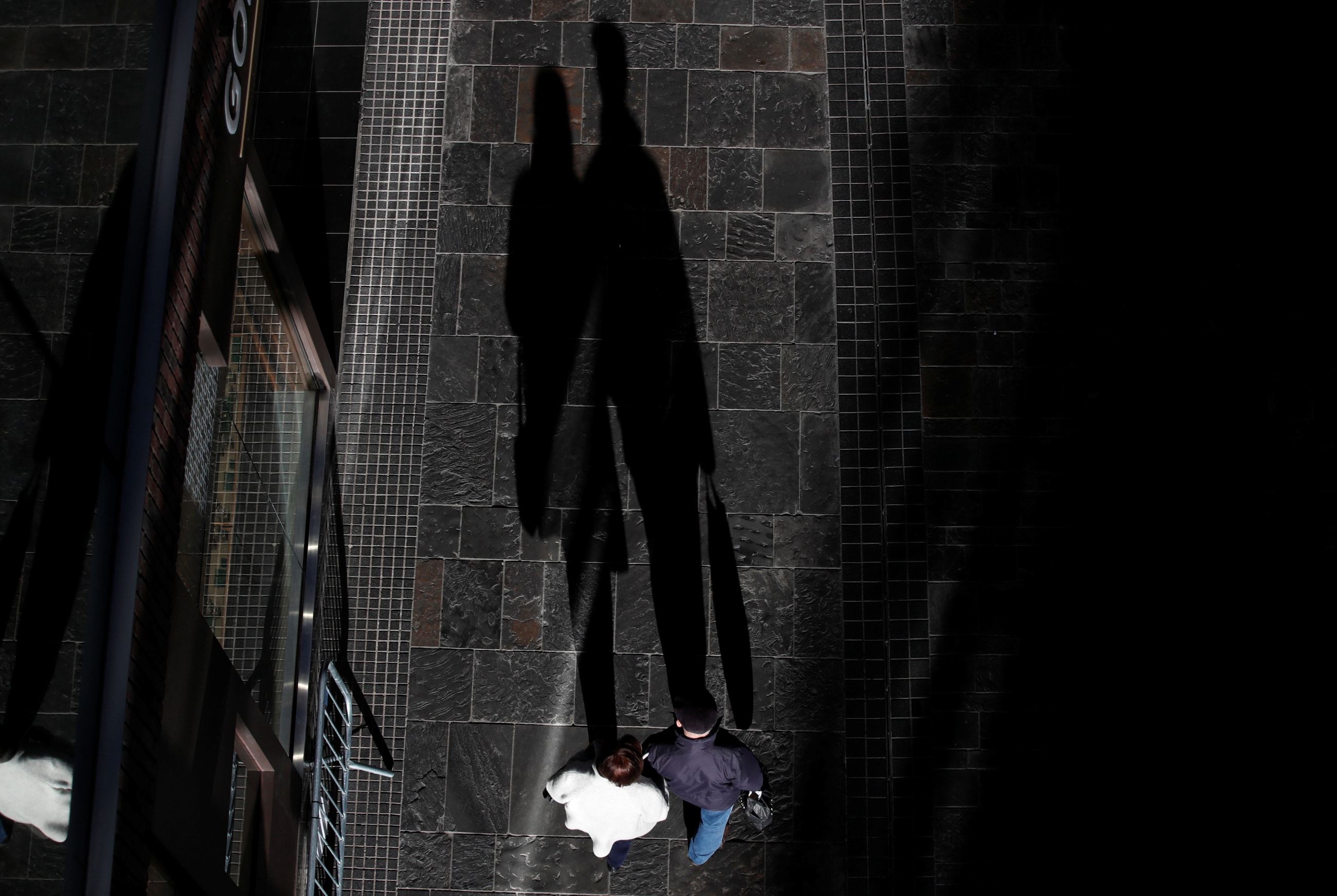 Shadows of shoppers are seen, after new nationwide restrictions were announced during the COVID-19 outbreak, in Bristol, Britain, on November 4, 2020. 