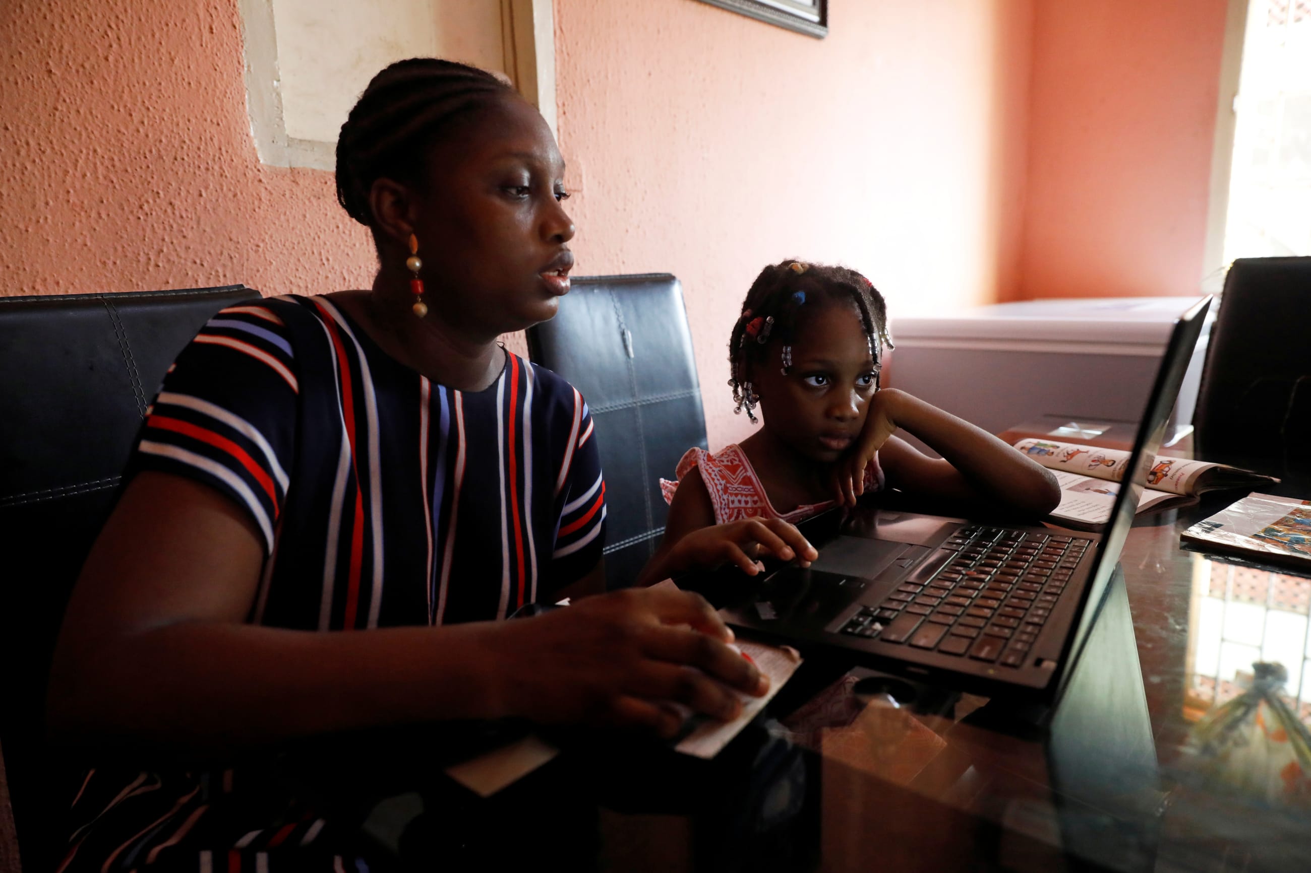 Kesieana Onoge and her daughter Naomi Onoge, 6, struggle to navigate the online learning system from their home, in Lagos, Nigeria, on April 23, 2020.