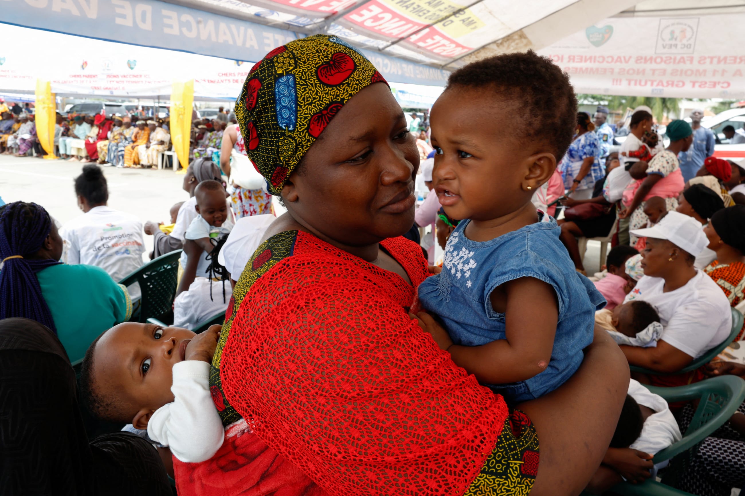 A woman waits to have her twins vaccinated during the official ceremony for the launch of the malaria vaccination campaign for children aged between zero and eleven months, in Abobo a district of Abidjan, Ivory Coast, on July 15, 2024. 