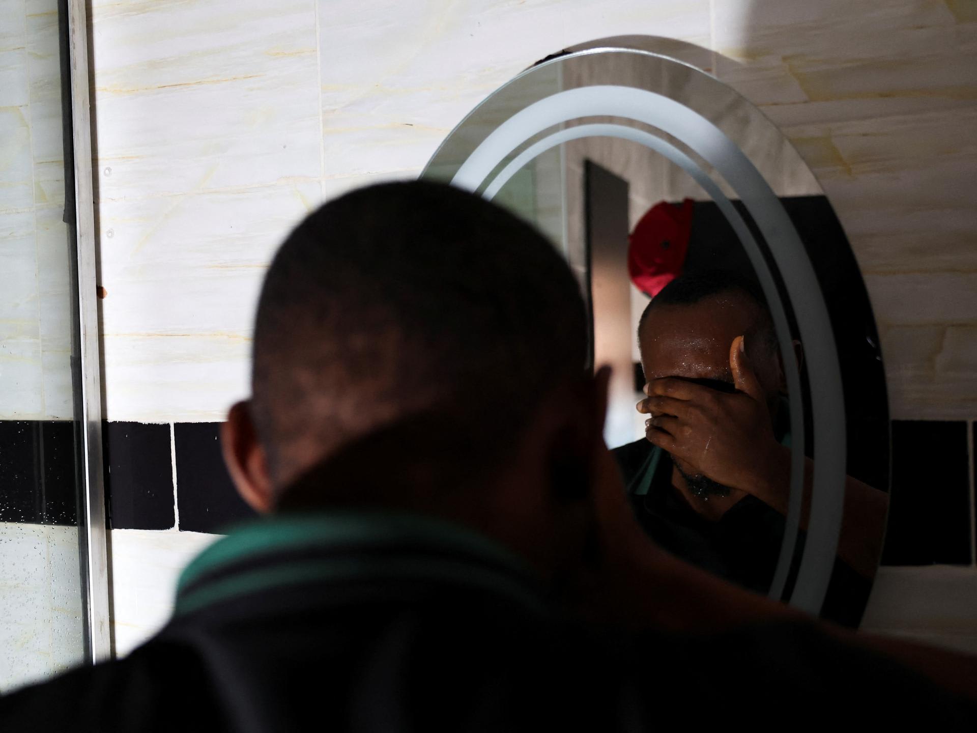 A person who contracted HIV after losing access to PrEP, washes his face, in Asaba, Delta State, Nigeria, on May 31, 2025.  