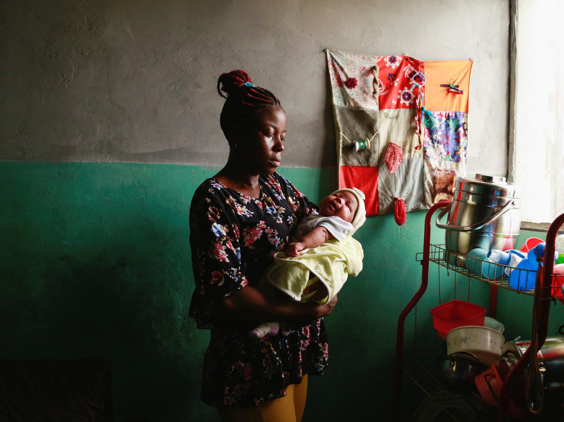 Jocelyne Mitoba, who was detained for eight days with her baby for lack of money at Bethesda Medical Center, holds her newborn at her home, in Ngaba, a neighborhood of Kinshasa, Democratic Republic of Congo, on February 18, 2023.