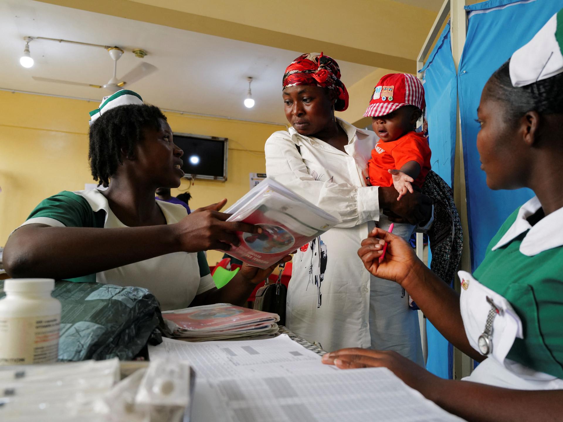Health workers attend to a mother and her infant, at the Mother and Child Hospital, in Kasoa, Ghana, on November 19, 2025.