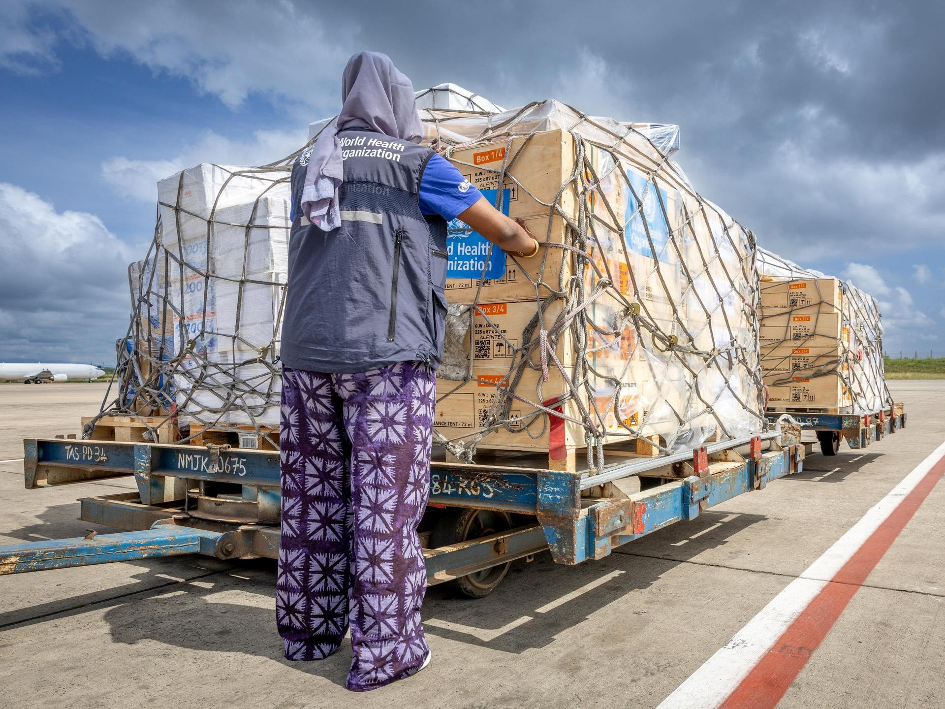 The regional supply chain lead for emergencies at the World Health Organization's Regional Office for Africa pastes stickers on shipment pallets that are being sent in response to the Ebola outbreak in the Democratic Republic of Congo, in Nairobi, Kenya, on May 18, 2026.