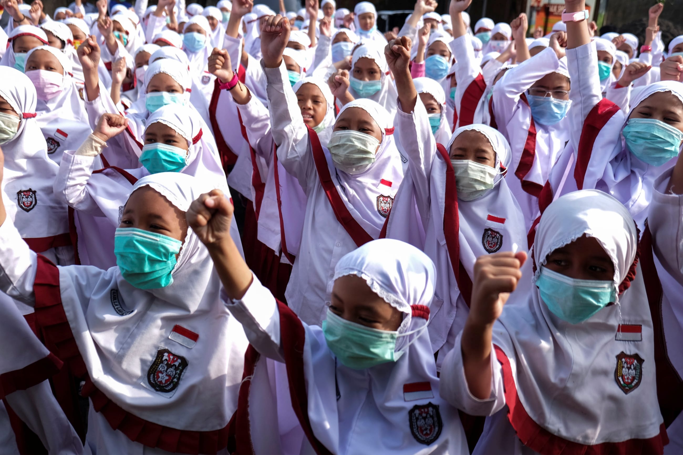 Students wear face masks during a health care action dedicated to coronavirus in Solo, Central Java, Indonesia on February 3, 2020