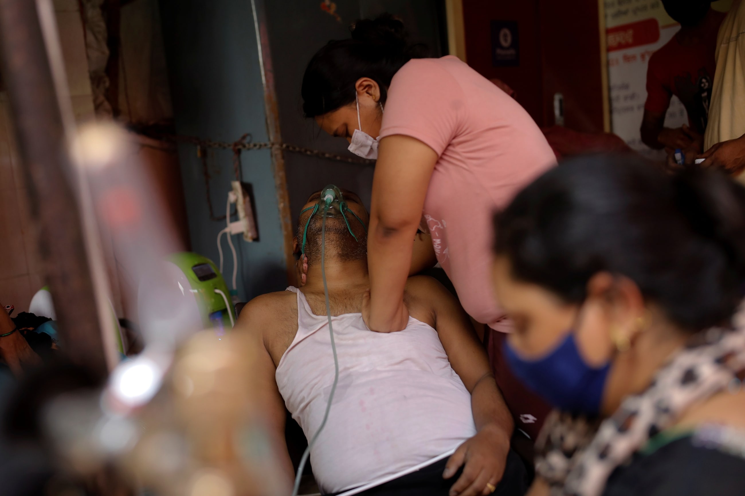  presses the chest of her father, who is suffering from breathing problem, after he felt unconscious while receiving oxygen support for free at a Gurudwara (Sikh temple), amidst the spread of coronavirus disease (COVID-19), in Ghaziabad, India, April 30, 2021.