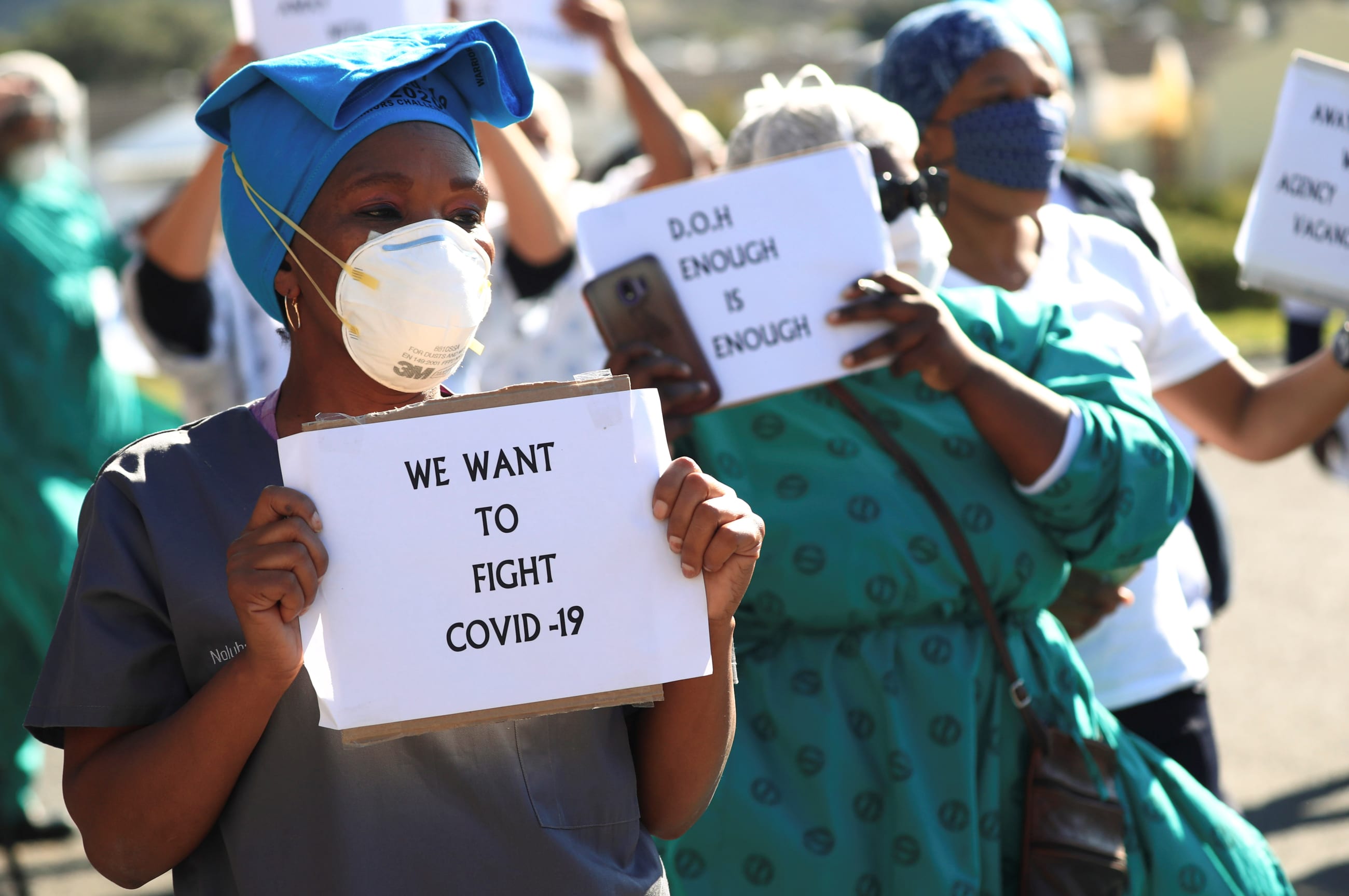 Health care workers holding signs, protest over the lack of personal protective equipment (PPE) during the coronavirus disease (COVID19) outbreak, outside a hospital in Cape Town, South Africa, June 19, 2020.