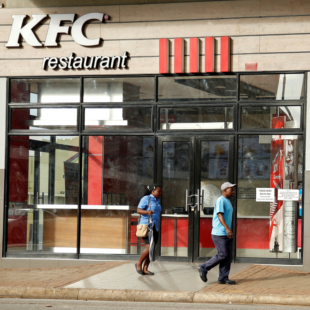 People walk past a KFC outlet in Harare, Zimbabwe, on January 16, 2019.