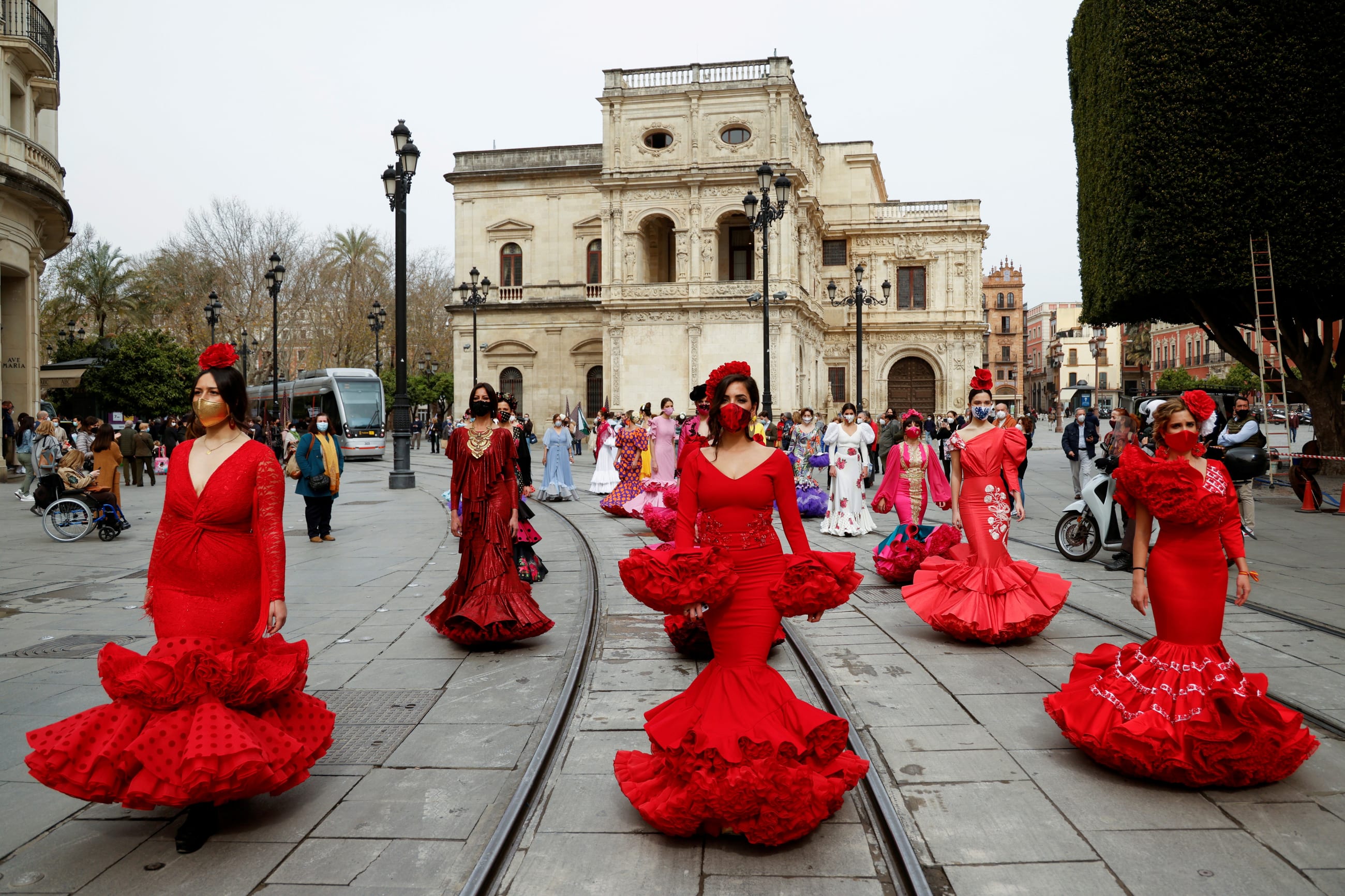 Women wearing flamenco dresses take part in a protest against the crisis in the flamenco fashion sector generated by the COVID-19 pandemic, in Seville, Spain, on February 26, 2021.