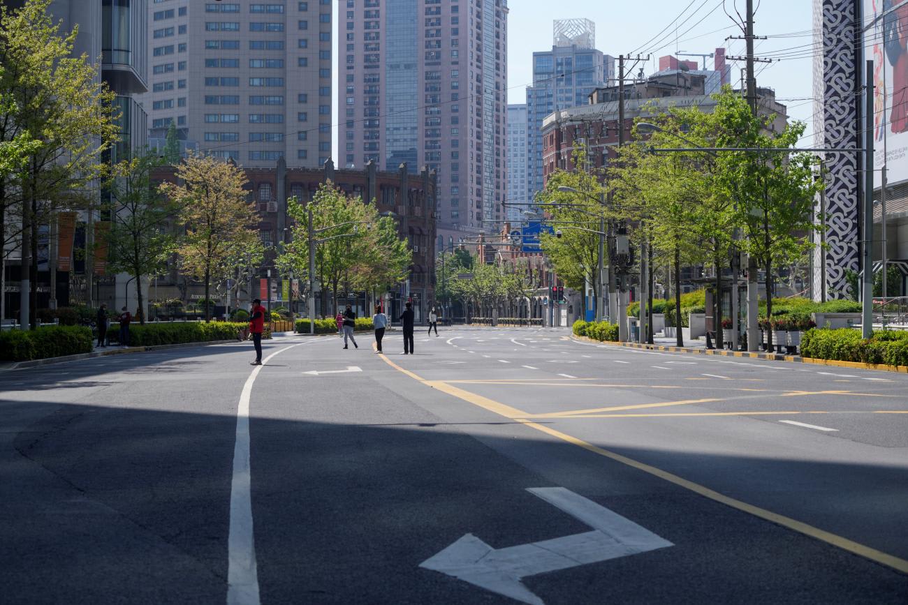 Residents stand on a deserted street waiting for COVID tests during a lockdown in Shanghai, China, on April 17, 2022.