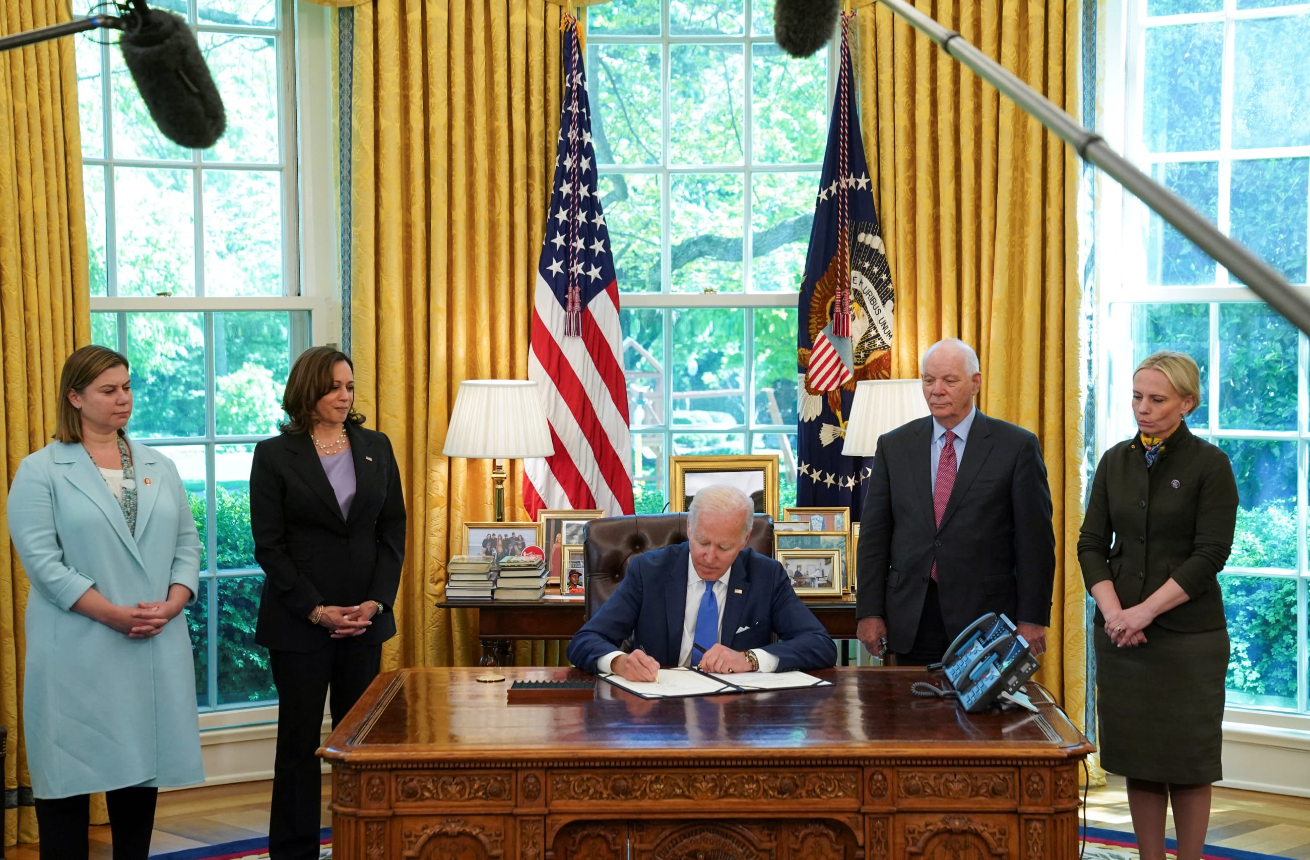 U.S. President Joe Biden sits at his desk and signs into law S.3522, the "Ukraine Democracy Defense Lend-Lease Act of 2022" at the White House in Washington, DC, on May 9, 2022.