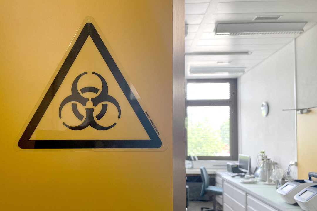 A large yellow biohazard sign on the wall at the bio-containment facility at Spiez Laboratory, available to WHO as a repository for COVID viruses and other pathogens with pandemic potential, in Spiez, Switzerland, June 8, 2022.
