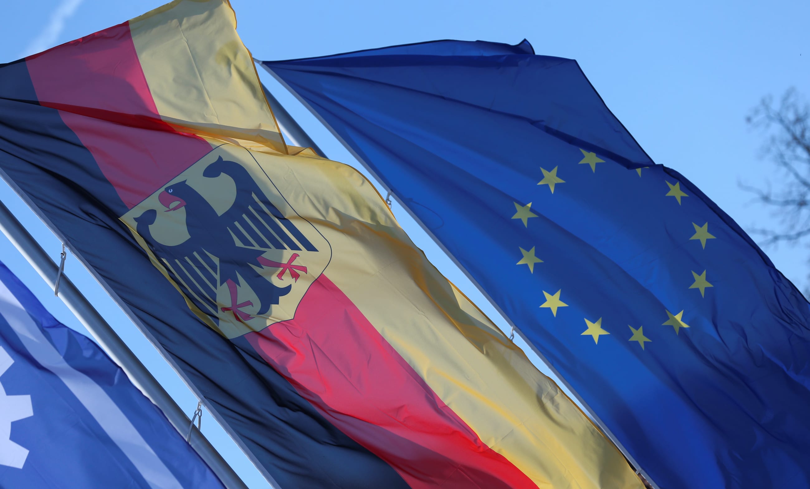 A German flag and a bluue flag with a circle of stars, the flag of the European Union, are pictured during police controls at the French border during the COVID-19 pandemic, in Saarbruecken, Germany, on March 16, 2020.
