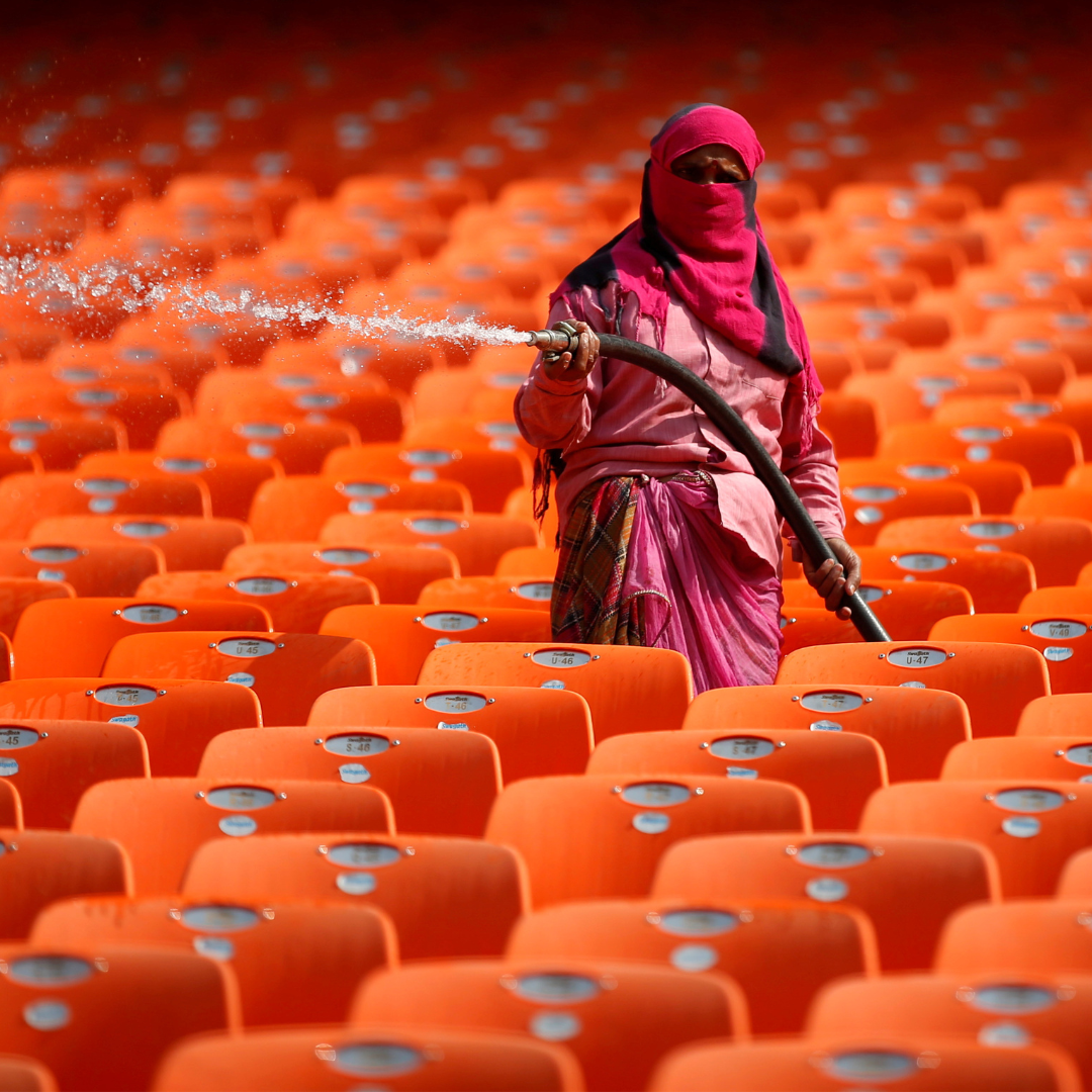 A worker hoses down the bright orange seats in the stands at Sardar Patel Gujarat Stadium, during the COVID-19 pandemic, in Ahmedabad, India, on February 17, 2021.
