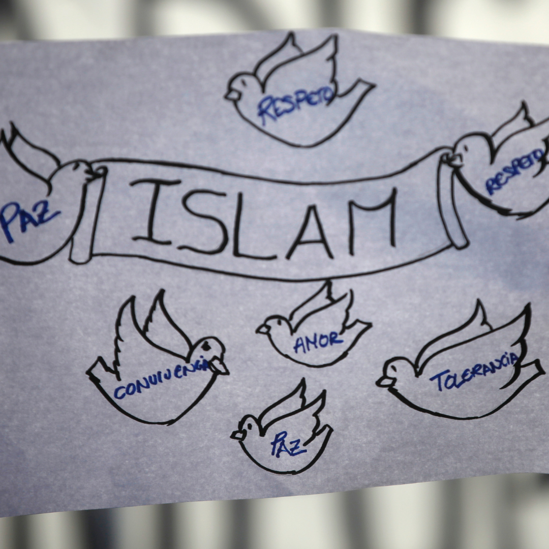 A girl holds a sign on white paper with black letters at a rally against Islamophobia in Madrid, Spain, January 2015. The words on the birds say, "Peace, Respect, Love, Tolerance, and Coexistence.”
