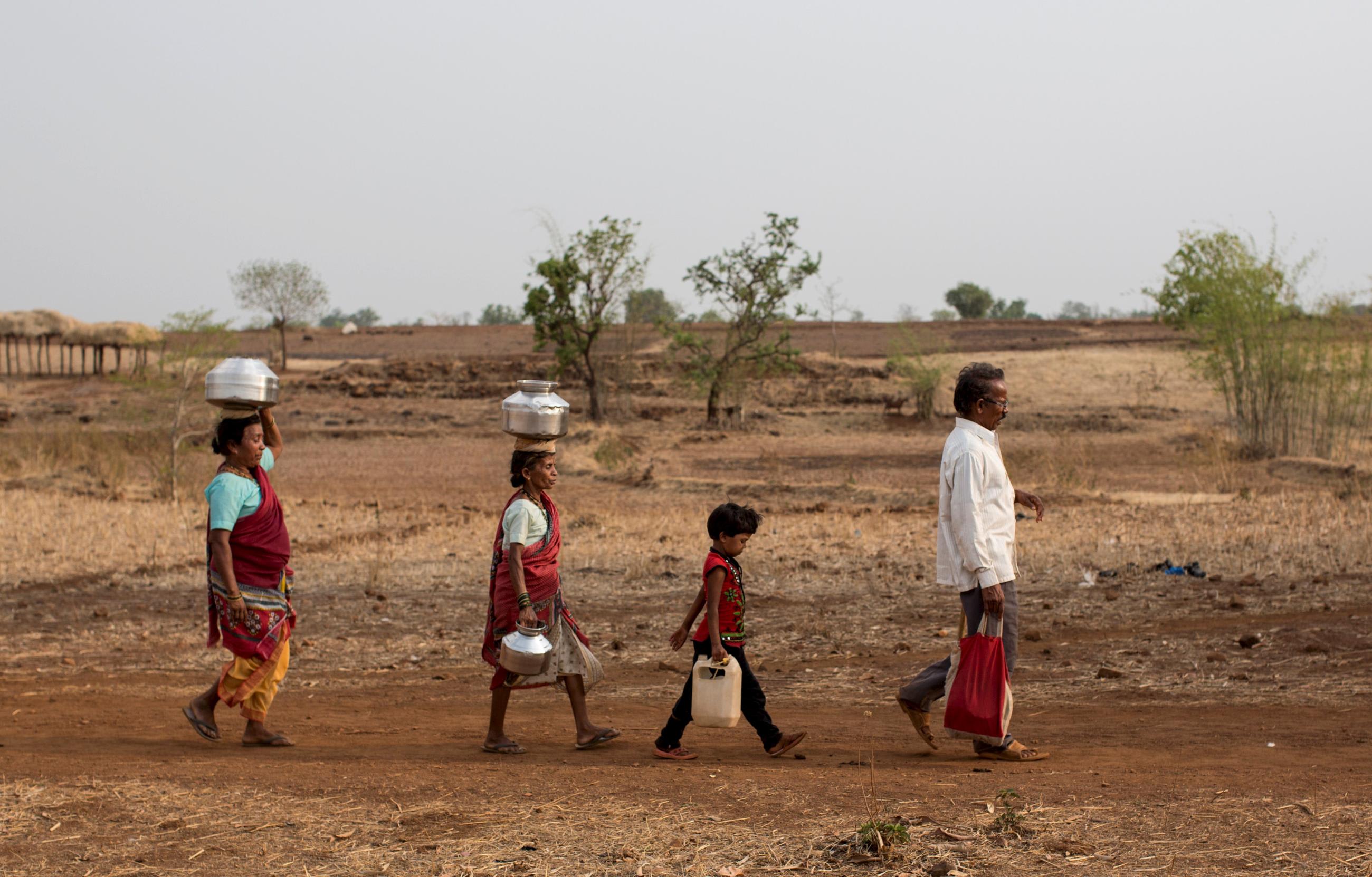 DOCUMENT DATE:&nbsp; June 04, 2015&nbsp; Bhaagi (left) and Sakhri (second from left), wives of Sakharam Bhagat (right) walk to fetch water from a well outside Denganmal village, Maharashtra, India, on April 20, 2015