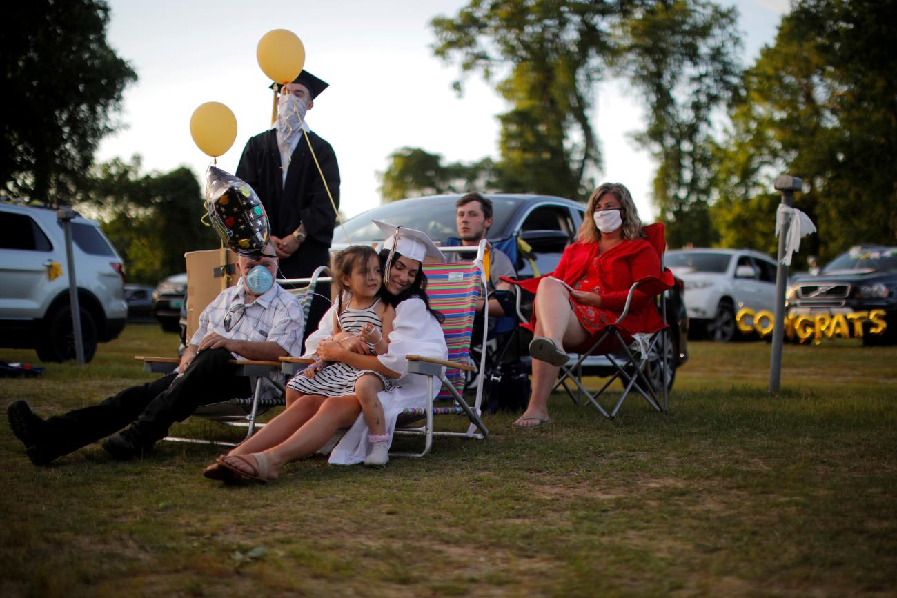 High school senior McKayla Glazier is joined by friends and family during Pioneer Valley Regional School's graduation, which was held in the Northfield Drive-In Theater because of the coronavirus disease (COVID-19) outbreak, in Hinsdale, New Hampshire, on June 8, 2020. 