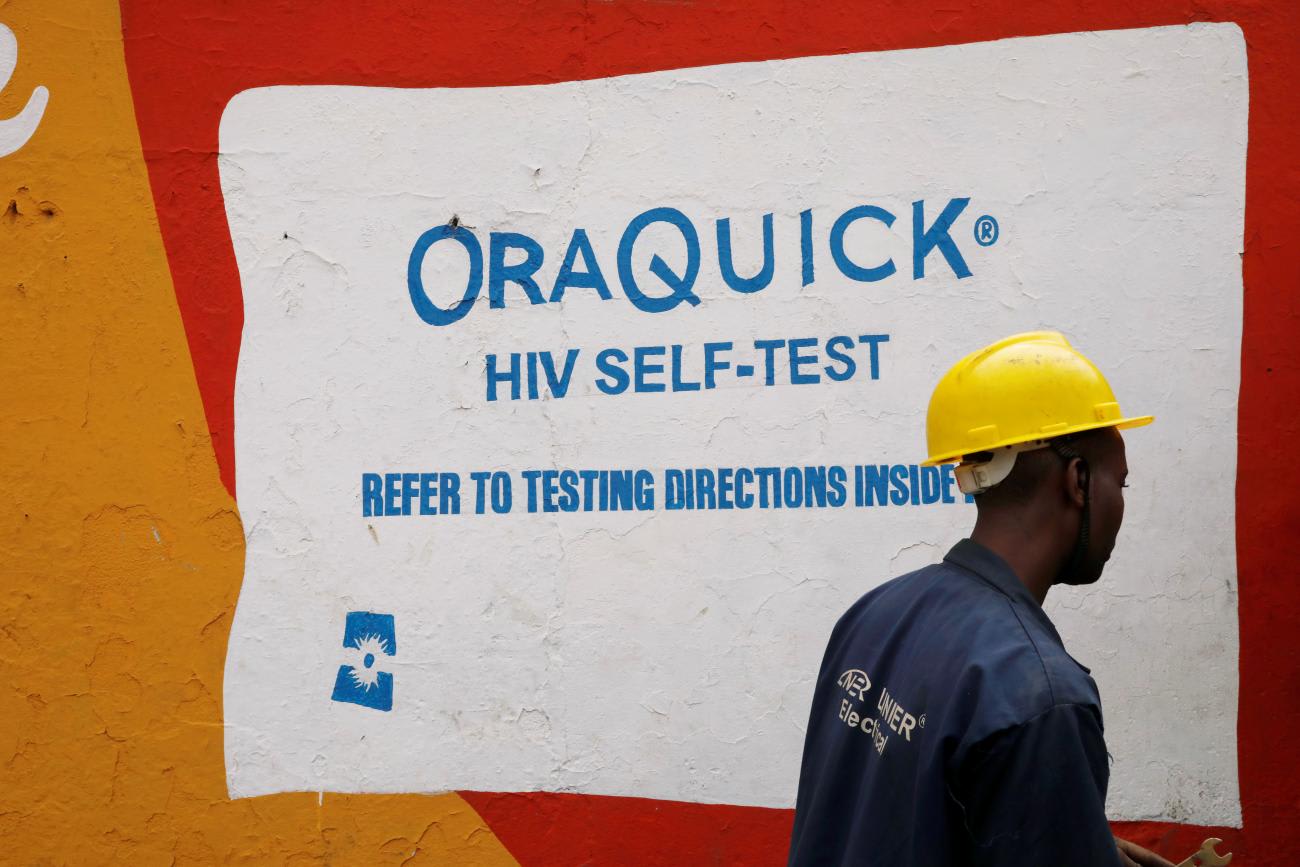A man walks past an advertisement for the OraQuick HIV self-testing kit, manufactured by Orasure Technologies, in the Mathare slum, in Nairobi, Kenya, October 30, 2020.