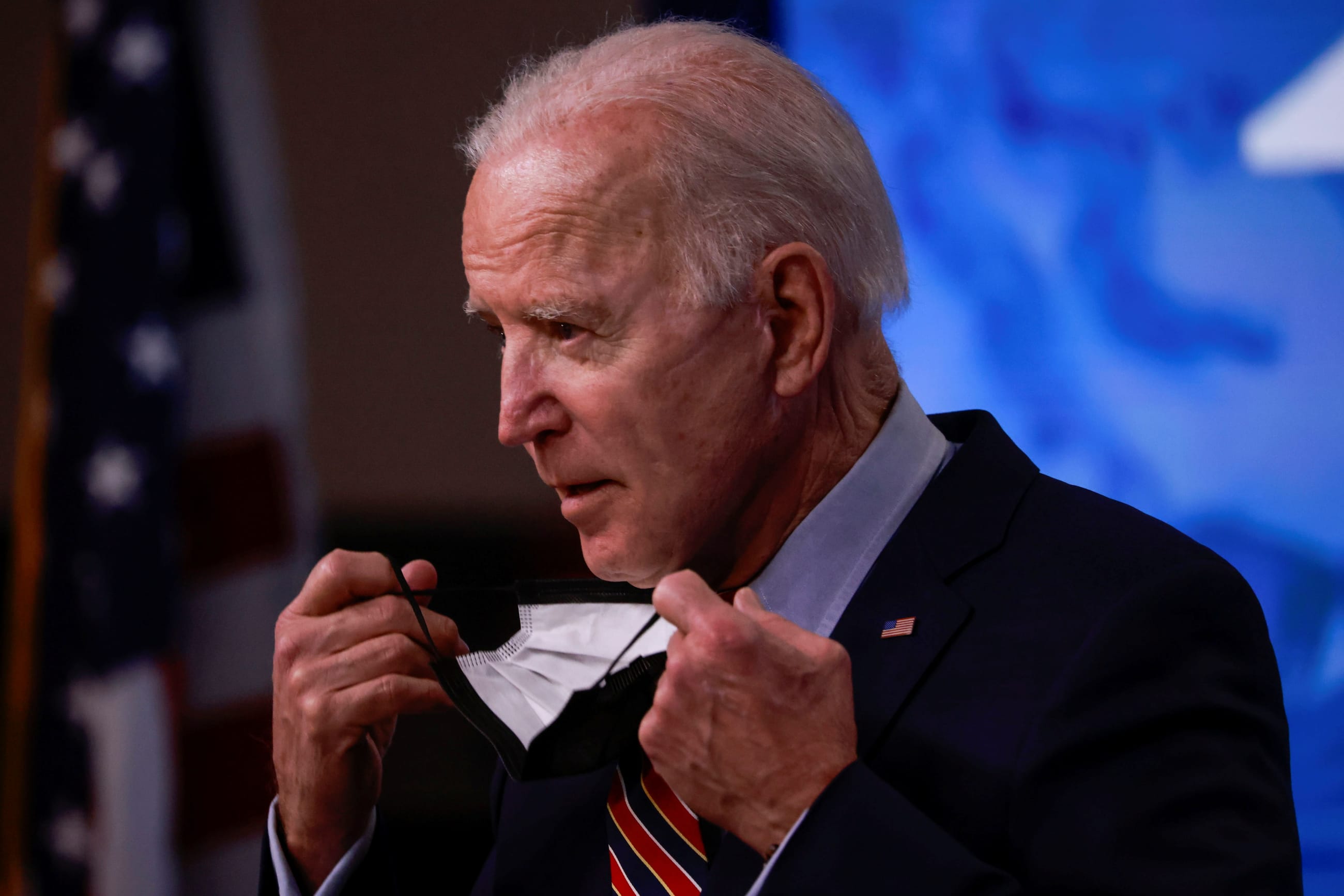 U.S. President Joe Biden removes his face mask to speak about the status of coronavirus disease (COVID-19) vaccinations and his administration's ongoing COVID-19 pandemic response in the Eisenhower Executive Office Building at the White House in Washington, U.S., April 21, 2021.