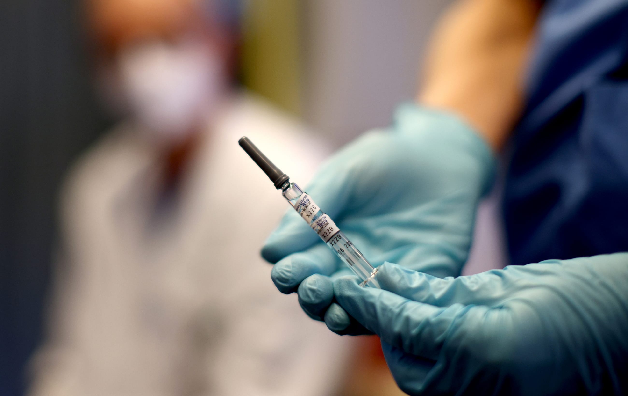 A health-care worker of the free influenza vaccination program holds a flu vaccine.